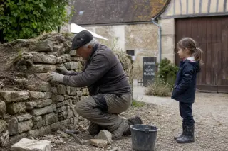 Norman courtyard with an artisan repairing an old stone wall, a young girl watching nearby, surrounded by timbered farm buildings under soft, diffuse daylight